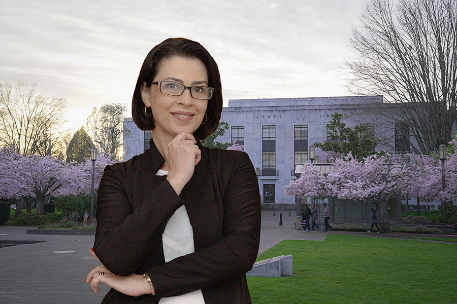 A middle-aged woman standing in front of the Oregon State Library