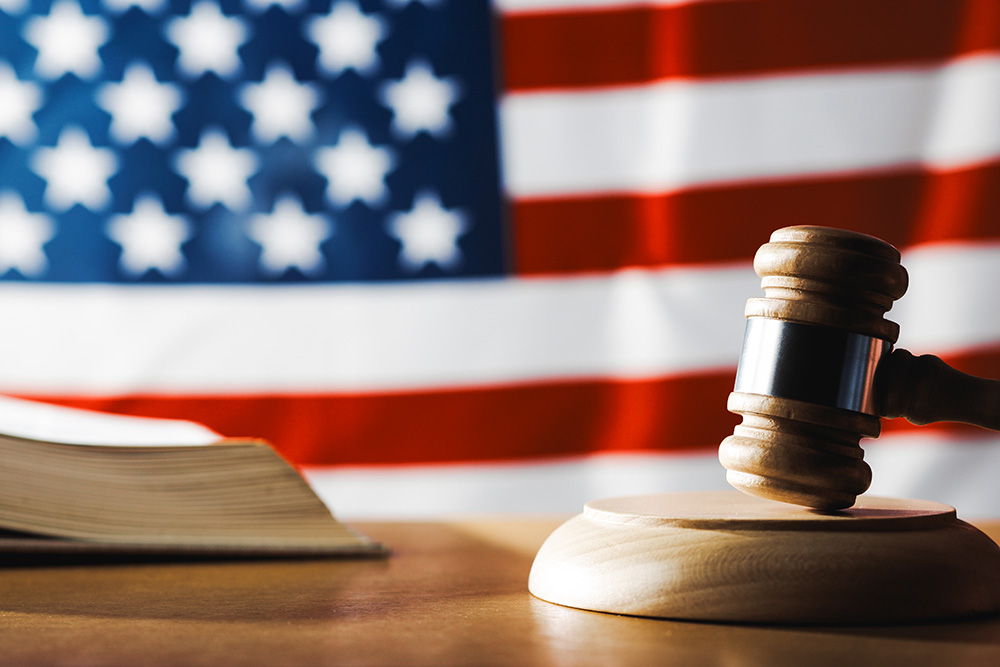 A gavel with a US flag in the background